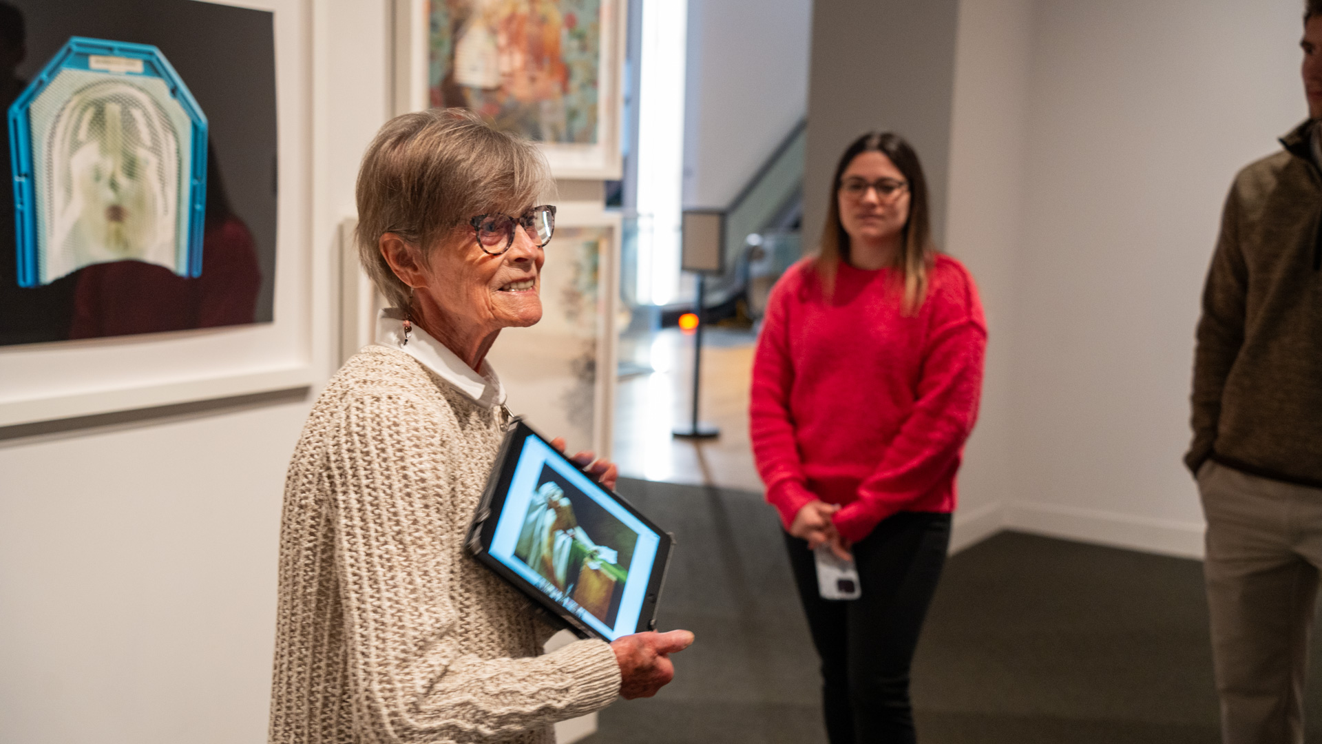 ArtBreak – Docent leading a tour 2 Docent with iPad speaking to group of people